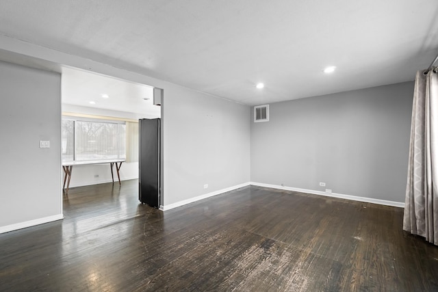 empty room with dark hardwood / wood-style floors