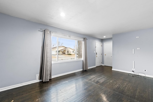 spare room featuring dark wood-type flooring