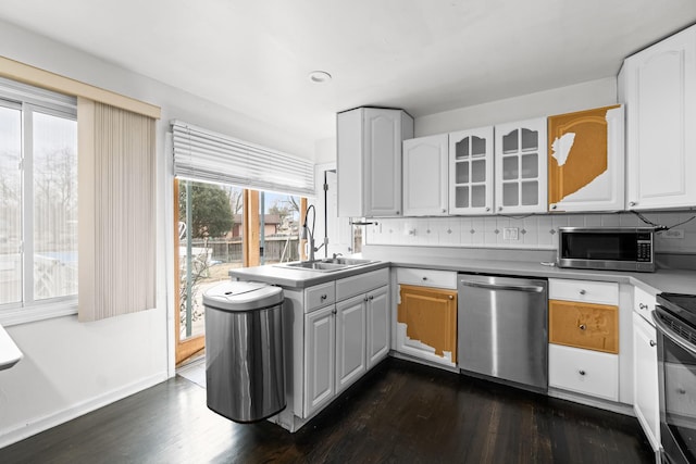 kitchen with white cabinetry, sink, tasteful backsplash, and appliances with stainless steel finishes