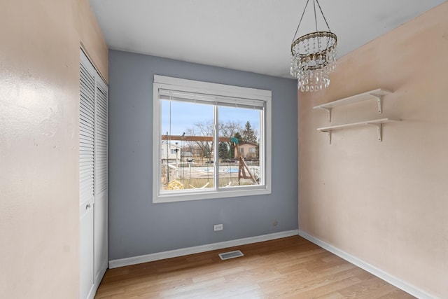 interior space with a notable chandelier and light wood-type flooring