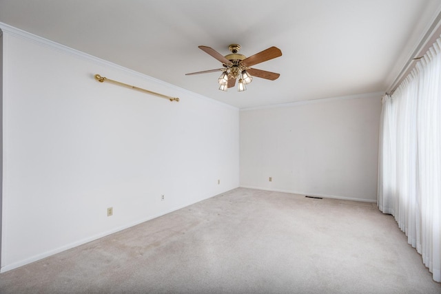 unfurnished room featuring crown molding, light colored carpet, and ceiling fan