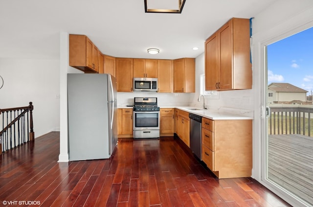 kitchen with sink, decorative backsplash, dark wood-type flooring, and stainless steel appliances