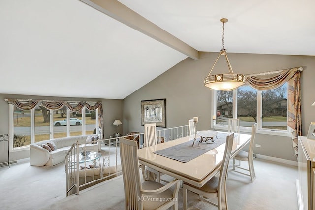 dining area featuring light carpet and lofted ceiling with beams