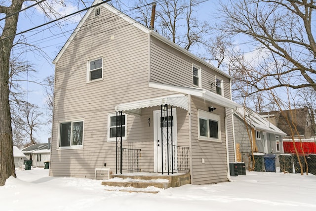 view of front of home featuring fence and central AC