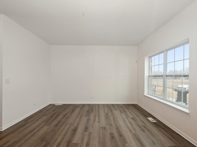 empty room with dark hardwood / wood-style floors