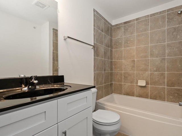 full bathroom featuring vanity, toilet, and tiled shower / bath