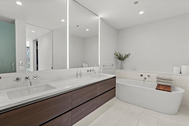 bathroom with vanity, a tub to relax in, and tile patterned flooring