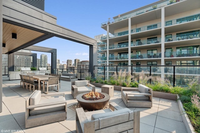 view of patio featuring an outdoor living space with a fire pit