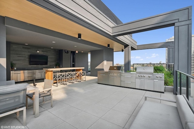 view of patio featuring area for grilling, grilling area, and an outdoor bar