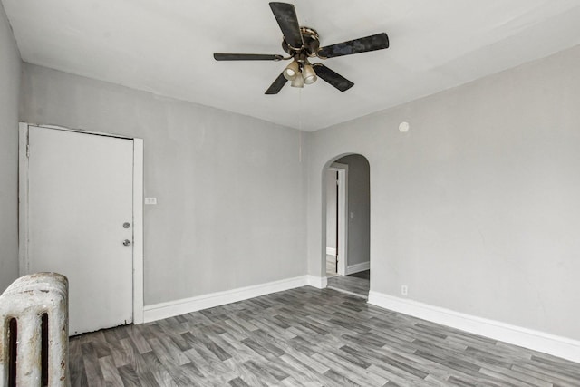 empty room featuring wood-type flooring and ceiling fan