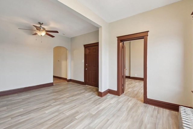 unfurnished room with ceiling fan and light wood-type flooring