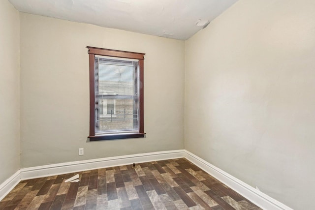 empty room featuring dark wood-type flooring