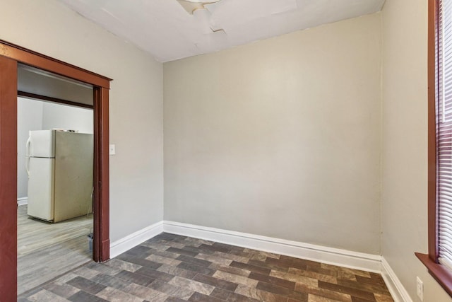 empty room with dark hardwood / wood-style flooring