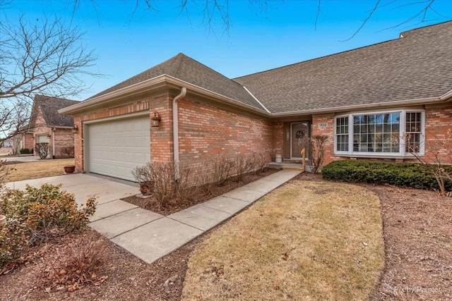 ranch-style house with a garage and a front lawn