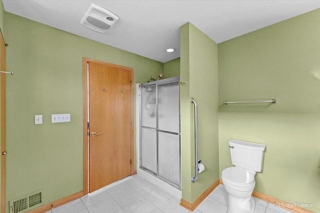 bathroom with an enclosed shower, tile patterned flooring, and toilet