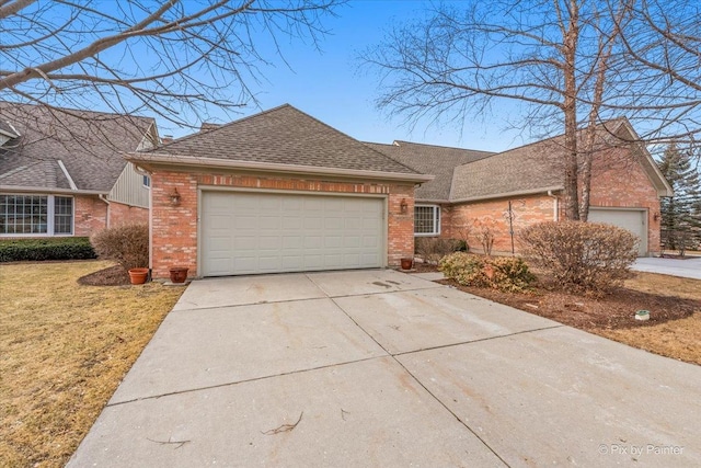 view of front of house featuring an attached garage, brick siding, driveway, roof with shingles, and a front yard