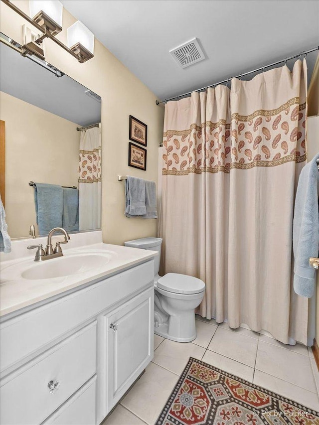 bathroom featuring tile patterned flooring, vanity, and toilet