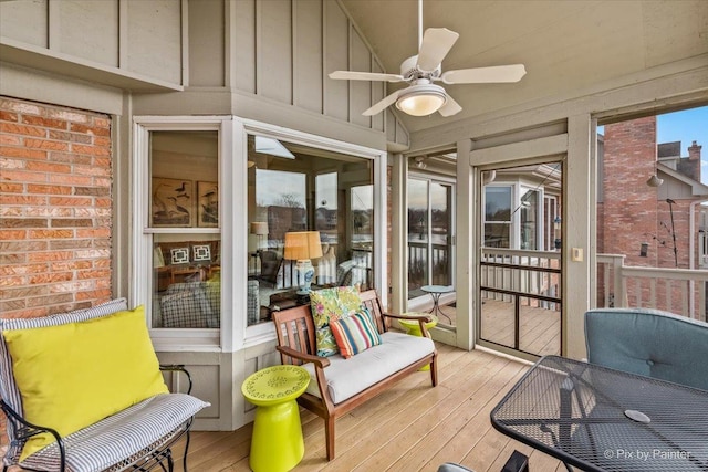 sunroom / solarium with lofted ceiling and ceiling fan