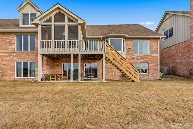 back of house featuring a lawn, a patio area, a sunroom, and central air condition unit