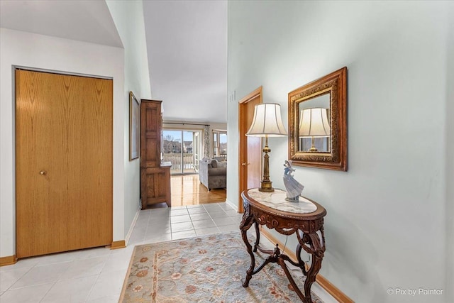 hall featuring light tile patterned flooring