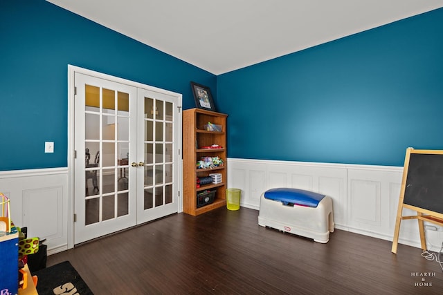 unfurnished room with french doors, wainscoting, and dark wood finished floors