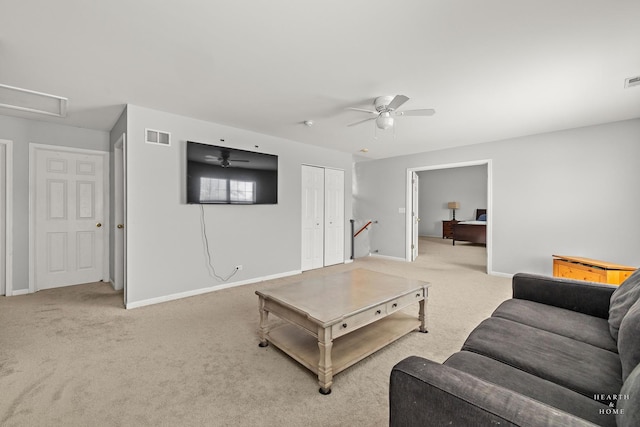 living room featuring carpet floors, baseboards, visible vents, and a ceiling fan