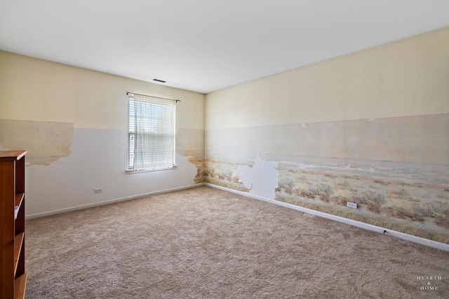 carpeted empty room featuring visible vents and baseboards