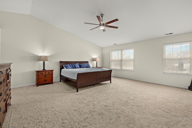 bedroom with light colored carpet, vaulted ceiling, visible vents, and baseboards