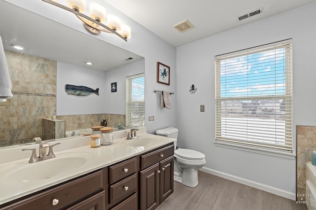 bathroom featuring double vanity, a sink, and visible vents