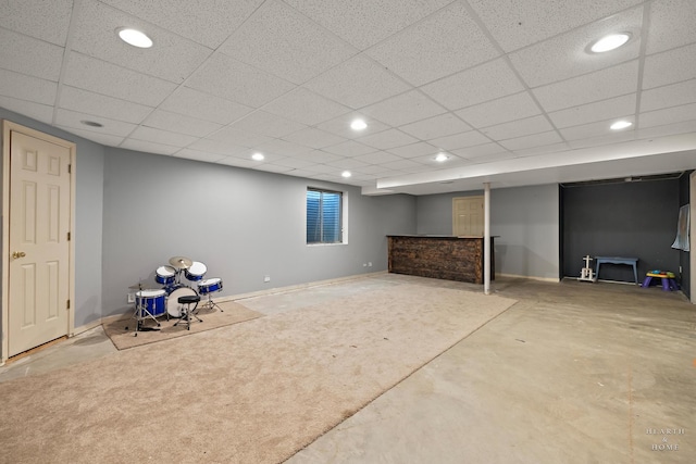 below grade area with recessed lighting, a paneled ceiling, and baseboards