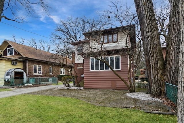 rear view of property with a lawn