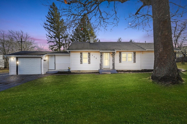 single story home with a garage and a lawn