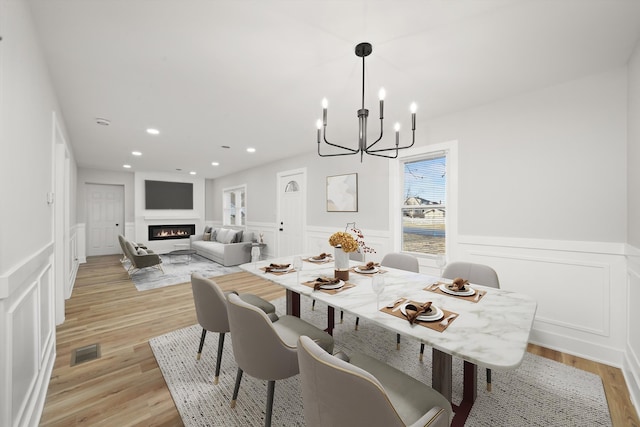 dining space featuring a chandelier and light wood-type flooring