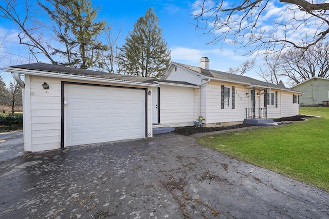 ranch-style house with a garage and a front lawn