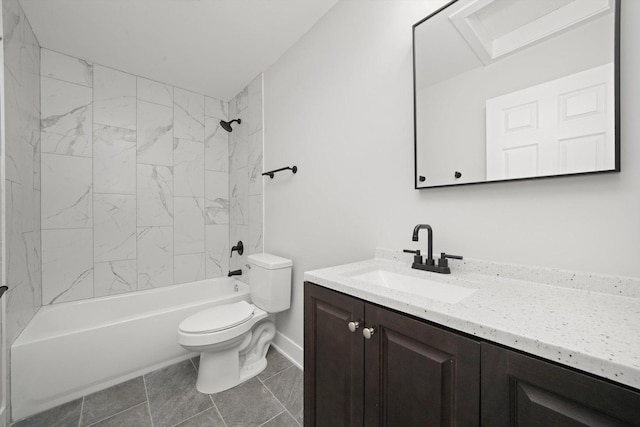 full bathroom featuring tiled shower / bath, vanity, and toilet