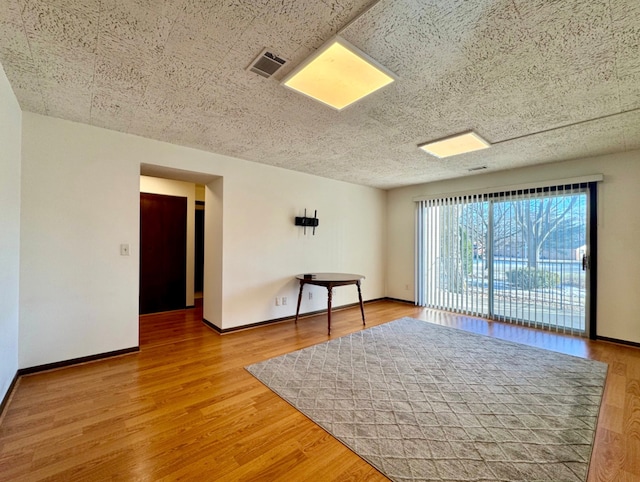 empty room with hardwood / wood-style flooring