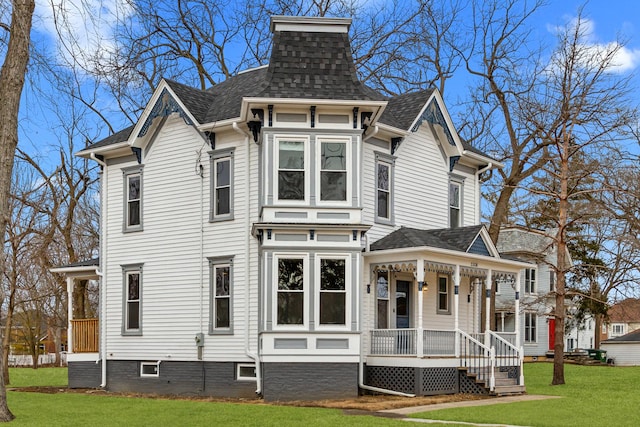 exterior space featuring a lawn and a porch