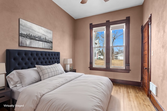 bedroom with ceiling fan and light hardwood / wood-style flooring