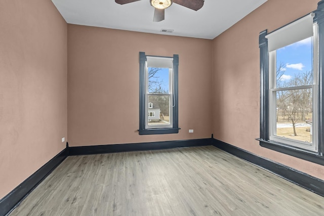 spare room with ceiling fan and light wood-type flooring