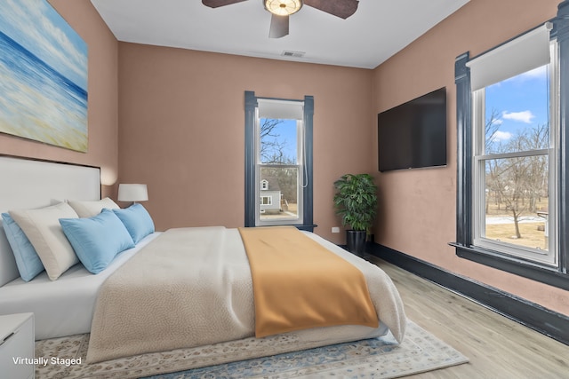 bedroom with ceiling fan and light wood-type flooring