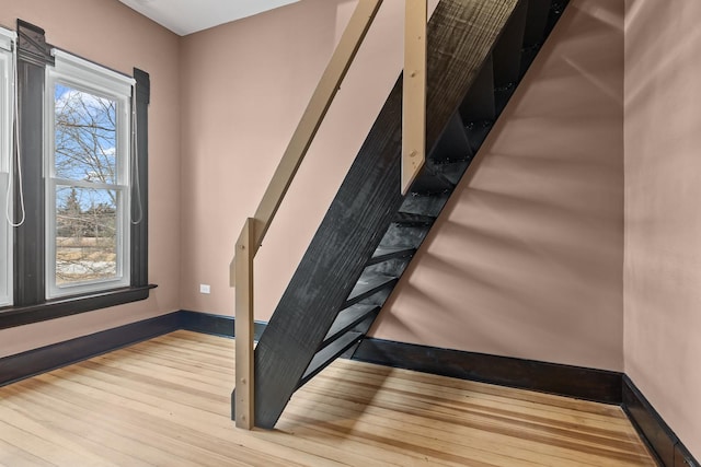 stairs with hardwood / wood-style floors