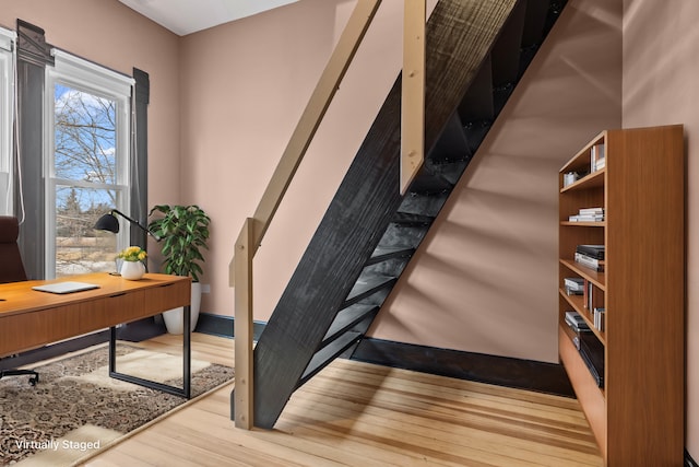 staircase featuring wood-type flooring