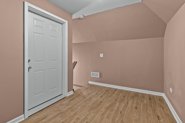 bonus room with lofted ceiling and light hardwood / wood-style flooring