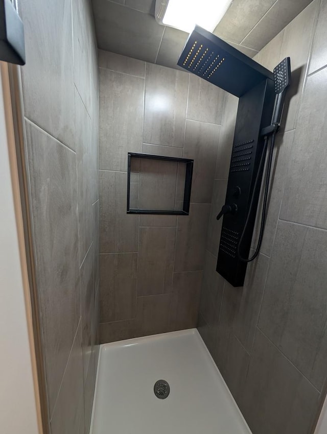 bathroom with a tile shower