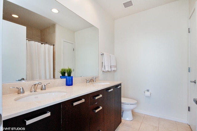 bathroom featuring tile patterned floors, toilet, and vanity