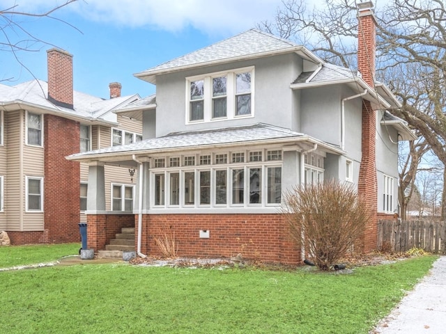 rear view of house featuring a yard