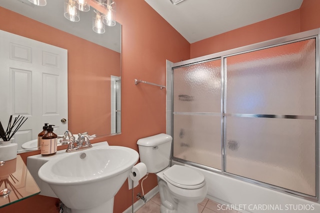 full bathroom with tile patterned floors, toilet, sink, an inviting chandelier, and shower / bath combination with glass door