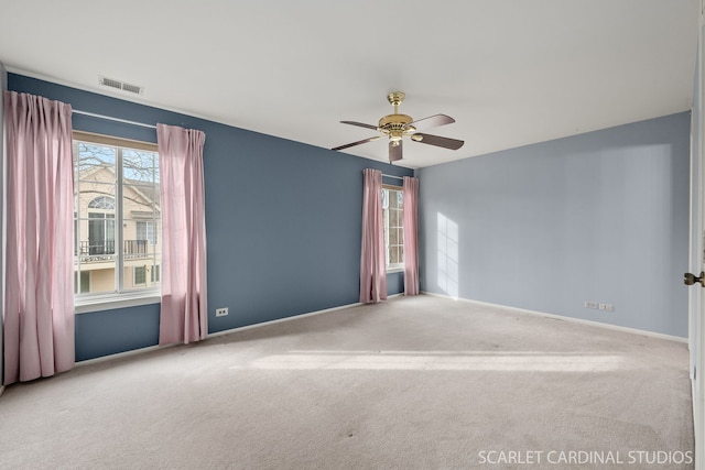 empty room with ceiling fan and carpet