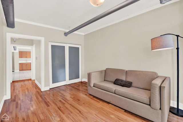 living room featuring crown molding, hardwood / wood-style flooring, and french doors