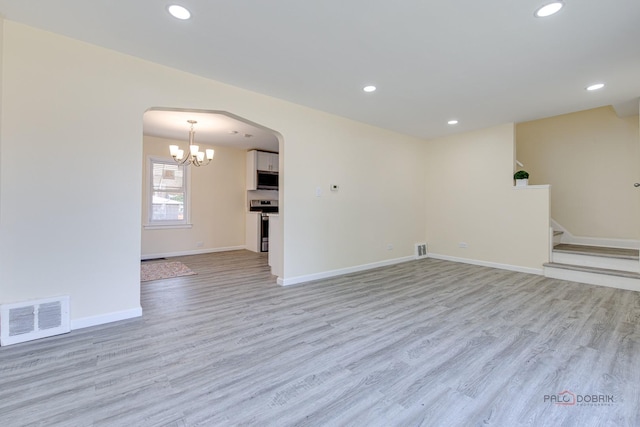 7345 S Washtenaw Ave, Chicago, IL 60629 - empty room featuring a notable chandelier and light hardwood / wood-style floors